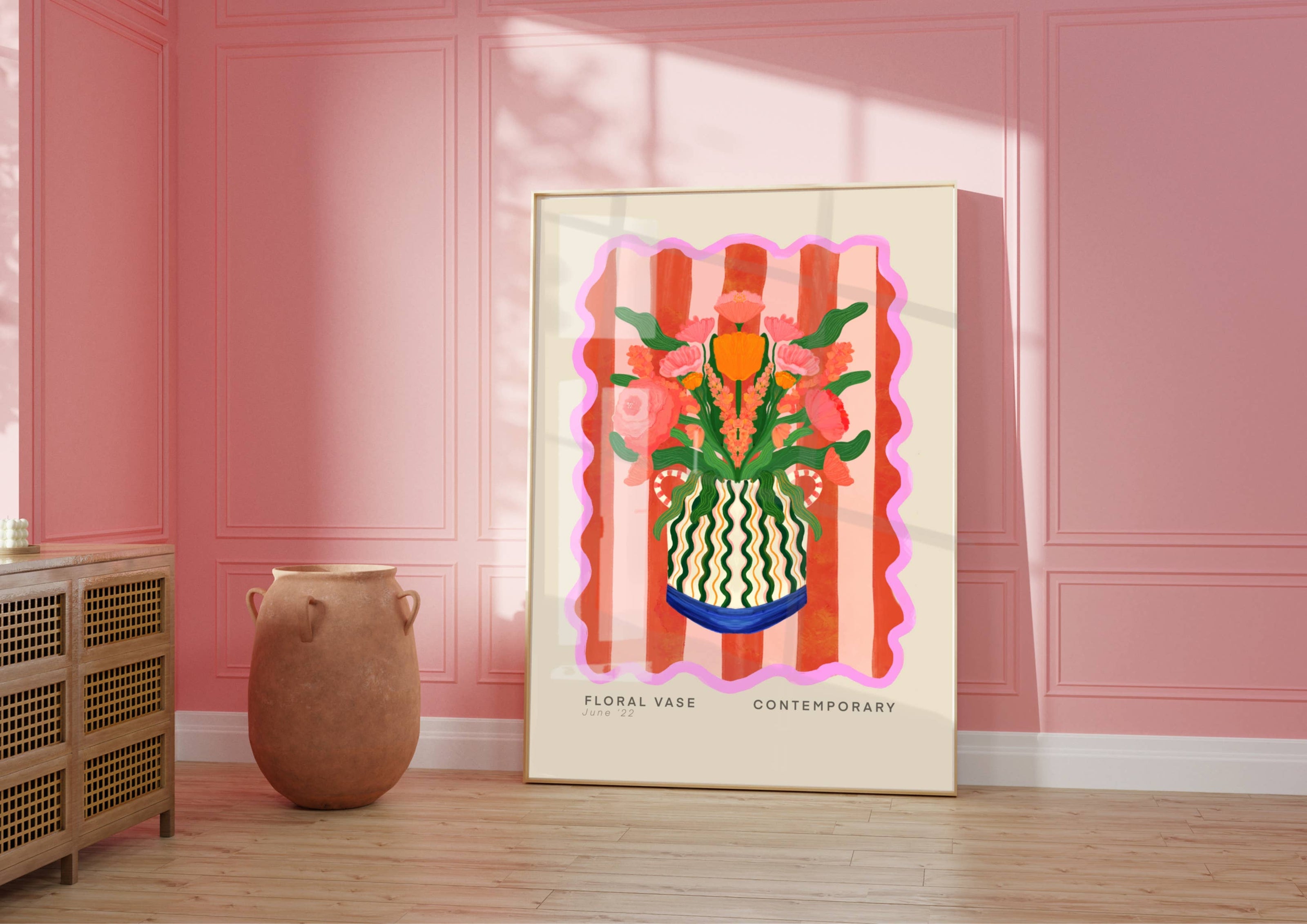 Framed artwork of a floral vase design on a pink wall with a vase and radiator in the foreground.