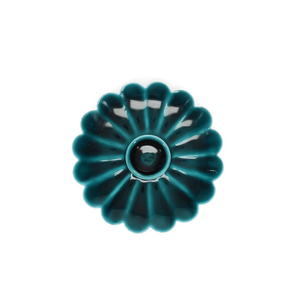 Teal ceramic candle holder on a white background