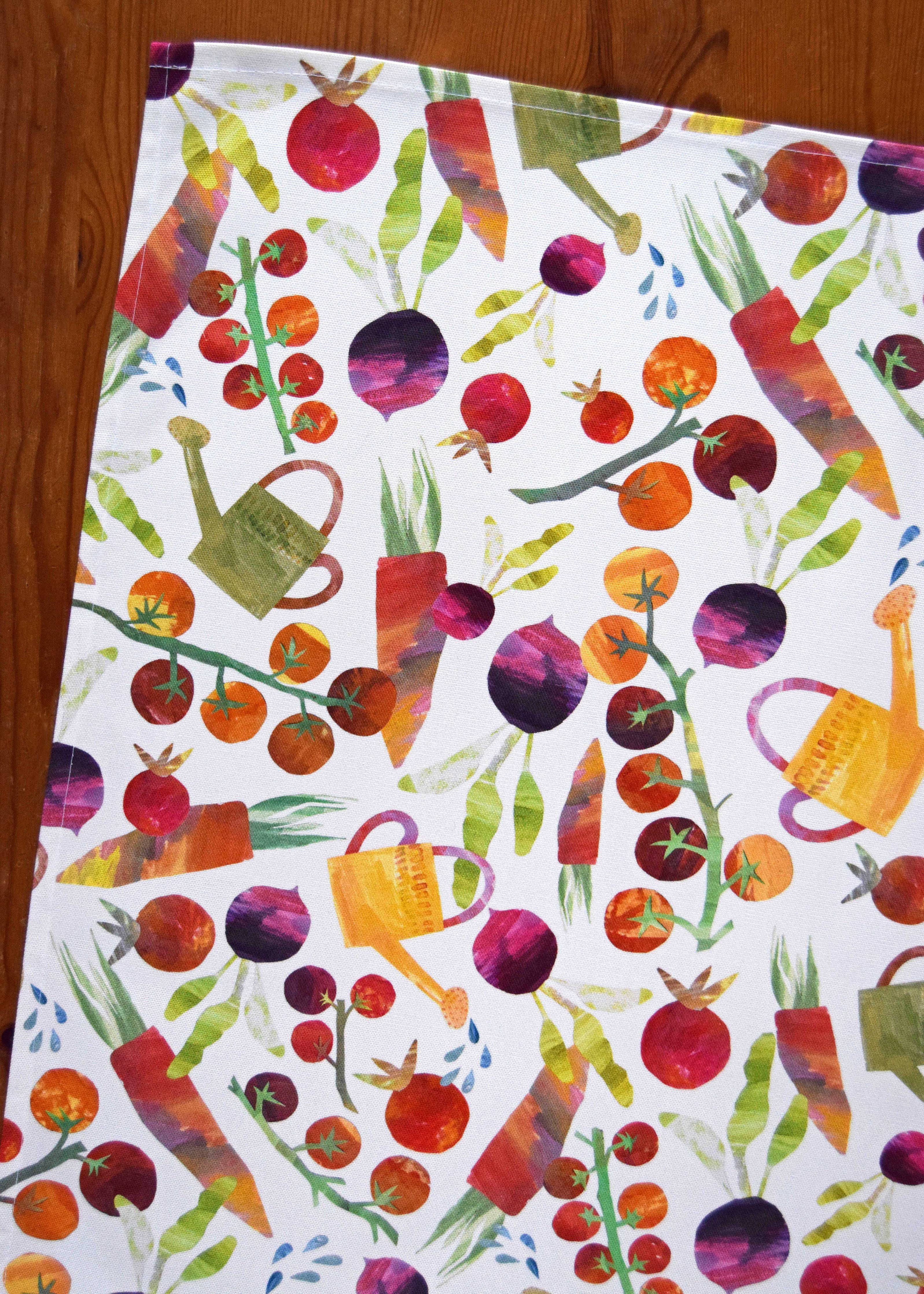 Colorful pattern of vegetables and watering cans on a white background