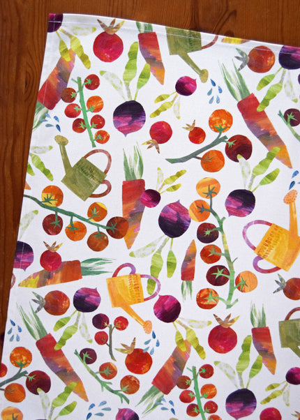 Colorful pattern of vegetables and watering cans on a white background