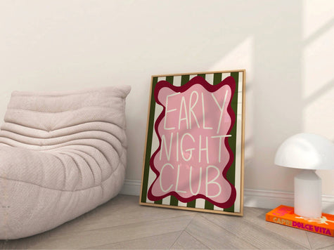 Framed artwork with 'Early Night Club' text in a room with a light-colored couch and lamp.