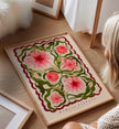 Framed floral artwork on a wooden floor with a person partially visible.
