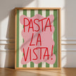 Framed artwork with 'Pasta La Vista!' text on a green and white striped background